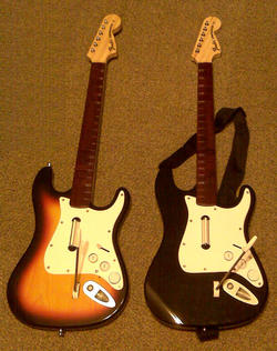 Side by side Rock Band 2 guitars: Replacement, left and original, right